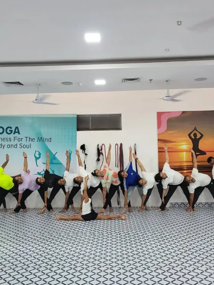 A wide shot of our group practicing Trikonasana (Triangle Pose) together. The alignment and synchronicity are beautiful to see.