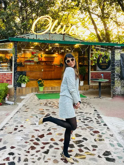 My birthday look outside a cafe. This tweed skirt and jacket set paired with black stockings is a classic and sophisticated choice for a winter celebration.