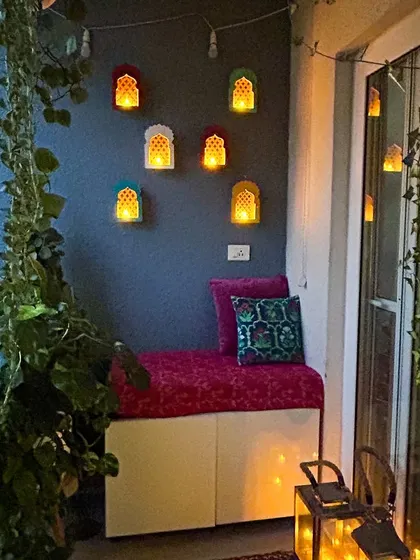 A magical evening look for the balcony, with jharokha-style wall lamps. It creates a very traditional and festive ambiance.
