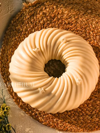 This is my 'Ethereal Halo Candle', a large, circular piece with a beautiful swirl pattern. It's designed for those who appreciate beauty in simplicity and casts a warm, tranquil glow.