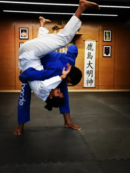 Executing a takedown during a BJJ Gi class. We teach a variety of throws and takedowns to ensure our students have a complete grappling game, from standing to the ground.