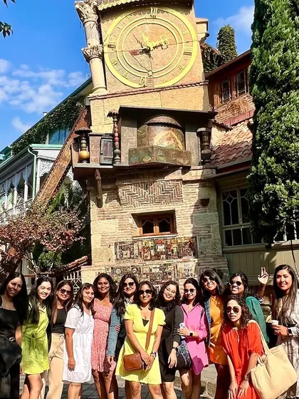 A girls' trip to Georgia is always a special experience. Here's our group enjoying the sights and making memories in front of Tbilisi's leaning clock tower.