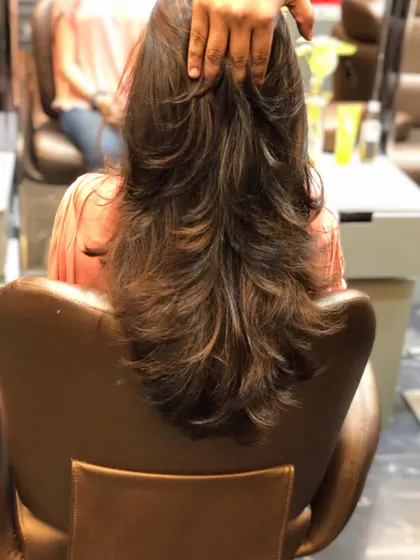 A similar multi-layered haircut, showing how the layers cascade down the back to create a textured look.