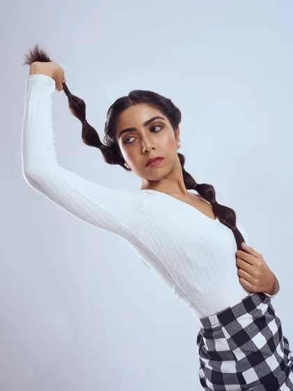 A playful and graphic look. I styled the hair in fun bubble braids and kept the makeup clean with a touch of shimmer on the eyes.