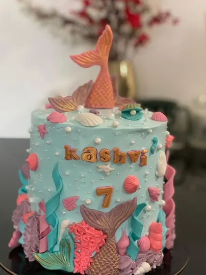 This mermaid cake was a special one for me as it marked the start of my baking journey. It's decorated with fondant tails, coral, and shells in pretty pastel colors.