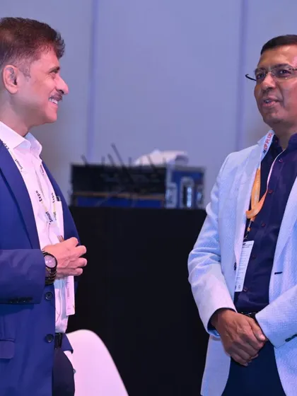 Professionals engaging in a conversation during a conference session break. The expo offers numerous formal and informal settings for valuable industry networking.