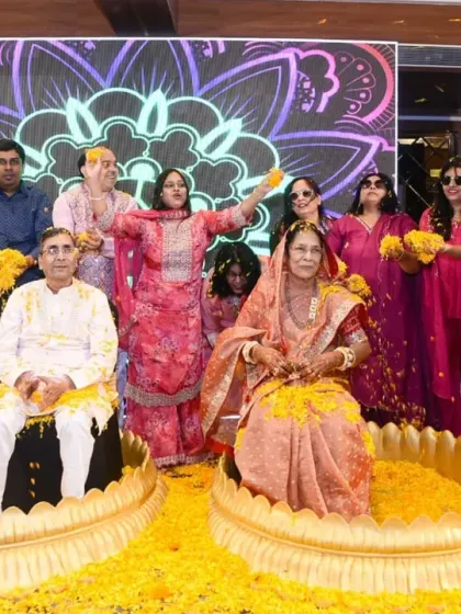 A fun and colorful moment as the couple is showered with flower petals by their family and friends.