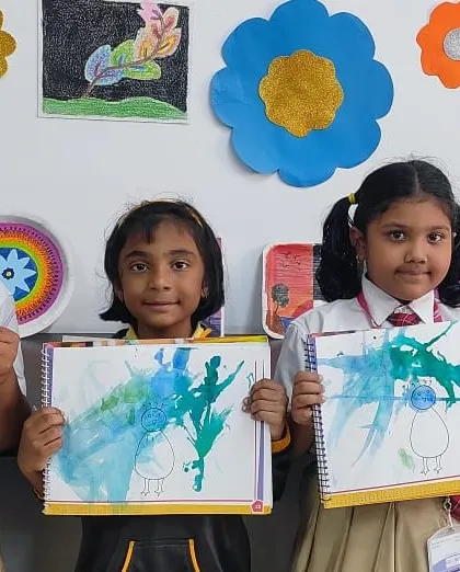Our youngest artists experiment with blow painting, creating unique and abstract designs with great enthusiasm.