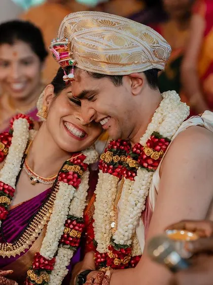 When you're truly in love, it shows. This candid shot captures a moment of pure, uninhibited laughter and affection between the couple during their ceremony.