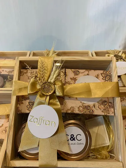 Custom gift boxes created for a corporate client, Renaissance Hotel. These elegant wooden crates are filled with curated local products and finished with a beautiful gold ribbon, a wax seal, and a branded tag.