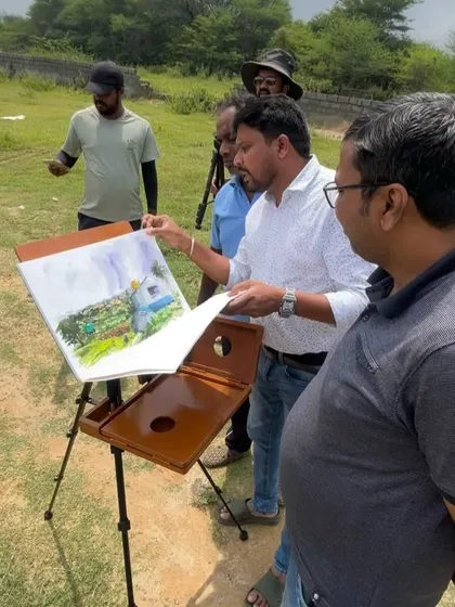 Showing my finished painting to fellow artists who were also painting on location. It's great to share feedback and see different interpretations of the same scene.