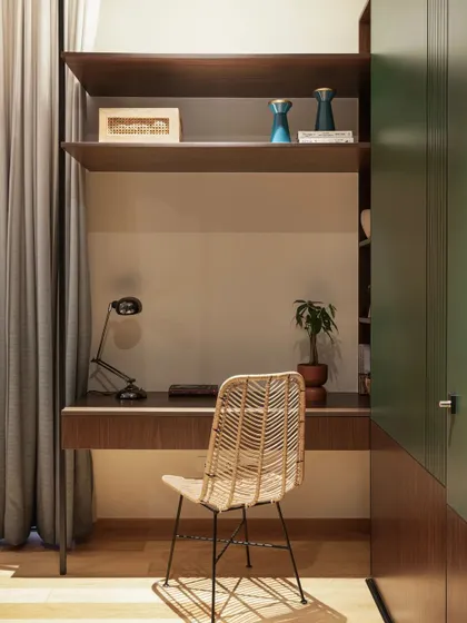 I infused this study nook with green and warm wood tones to create a natural, organic vibe. The comfortable cane chair is the perfect spot for study sessions, and the open shelving provides ample space for books and decor.