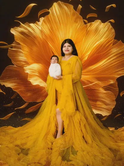 A mother holds her newborn, enveloped in a stunning yellow gown that resembles a giant flower.