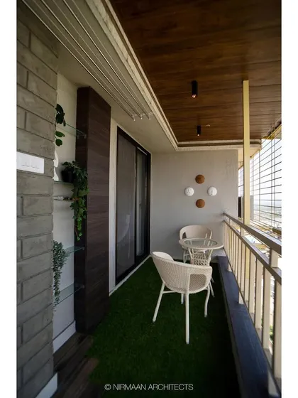 Another view of the bedroom balcony, showing the comfortable seating and the view. We design these spaces to be functional, private, and perfect for relaxation.