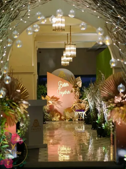The view through the fairy-lit twig archway, leading to the "Better Together" photo booth, creating a beautiful, layered entrance experience.