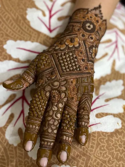 Another angle of the dense back-hand mehendi, showing the detail on the fingers.