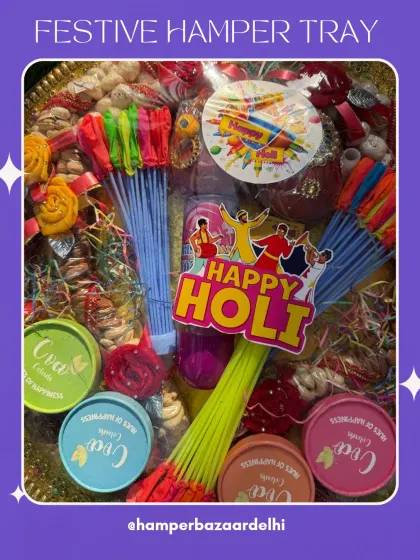 A close-up of the goodies in our Holi tray. You can see the colorful gulal tubs, water balloons, and festive stickers that make this hamper so much fun.