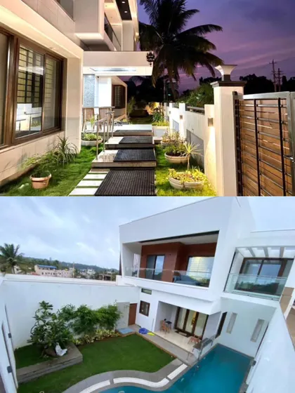 The home's design includes multiple landscaped areas and a pathway that leads from the gate to the entrance, creating a journey through greenery.