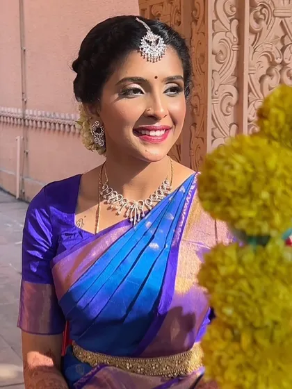 Another beautiful shot of our Veradam bride, with marigold flowers adding a pop of color. Her bright smile and radiant skin are the focus of this look.