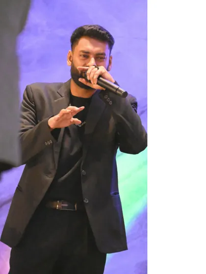 A full-body shot of me on stage at a club night. Dressed in a sharp blazer, I'm ready to bring both style and energy to the party.