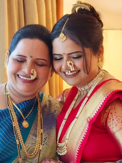 A lovely mother-daughter duo, both looking radiant in their traditional Marathi attire. It's always special to get multiple generations ready.