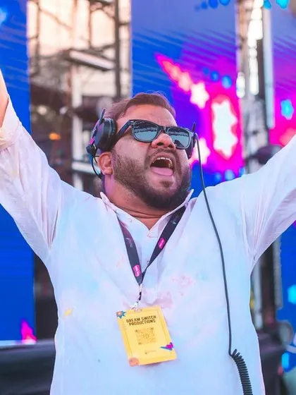 Hands in the air, feeling the love from the massive Holi crowd. An unforgettable moment.