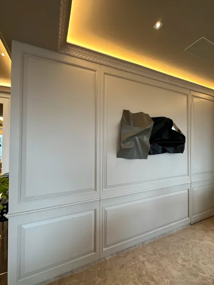 The sculpture seems to float on the beautifully crafted wall.