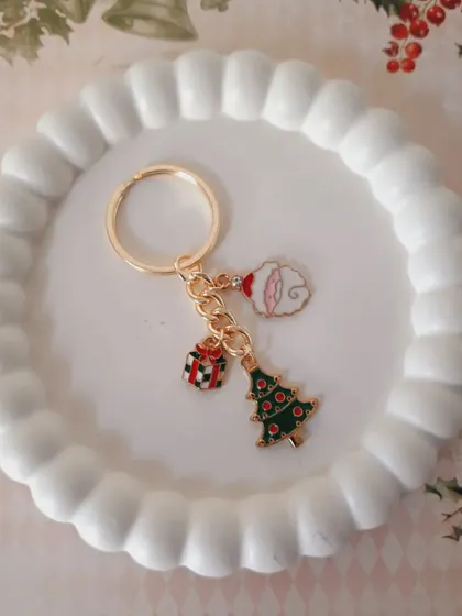 A custom Christmas keychain featuring a Christmas tree, a gift, and a Santa moon charm. This is a great example of how you can mix and match my charms.