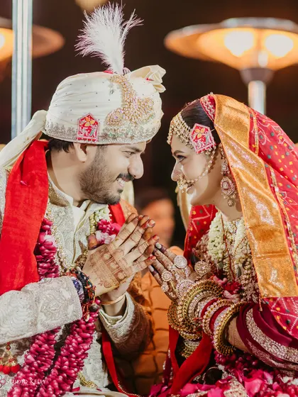 A beautiful, candid moment of the couple sharing a traditional greeting during their royal Rajasthani wedding.
