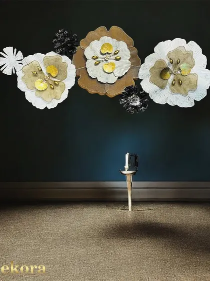 This dramatic floral wall art, set against a dark wall, showcases how our pieces can create a moody and sophisticated atmosphere. The lighting highlights the 3D form and metallic centers.