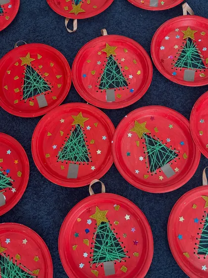 More of the wonderful Christmas tree string art. The bright red plates make the green trees pop!