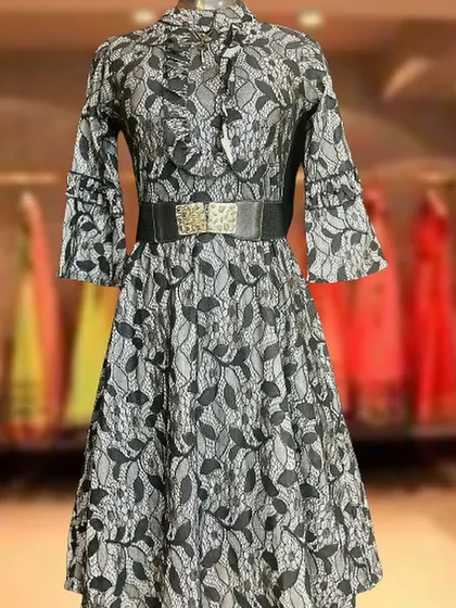 A sophisticated black and white lace dress with bell sleeves and a high neckline. The included belt adds structure to this elegant piece, making it suitable for office parties or formal dinners.