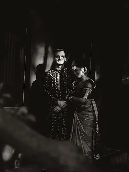 A dramatic black and white portrait of a couple, the shadows and light creating a mysterious and romantic mood.