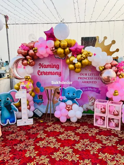 A slightly different angle of the princess naming ceremony, showing the crown and moon foil balloons that add a touch of royalty and magic.