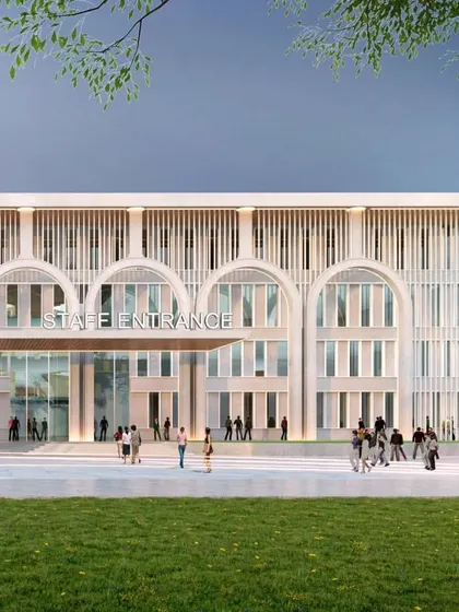 The staff entrance of the Mayo Institute teaching block maintains the design's elegant and formal language. The facade's rhythmic pattern of arches and vertical screens provides a sense of order and institutional gravitas.