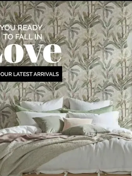 This bedroom setting features a beautiful, calming wallpaper with a bamboo leaf pattern. It shows how the right design can create a serene and loving atmosphere in your personal space.