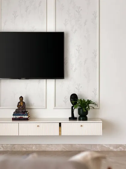 This TV unit combines a muted floral wallpaper with classic wall beading and a floating console with grooved drawers, creating a look that is both practical and visually stunning.
