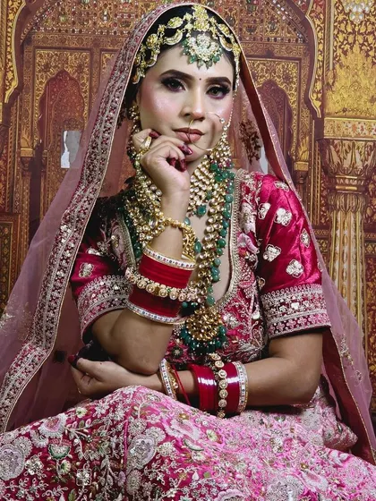 This bride wanted a truly opulent look. We designed a multi-layered set with a choker, a mid-length necklace, and a long green-beaded mala, complemented by a heavy matha patti.