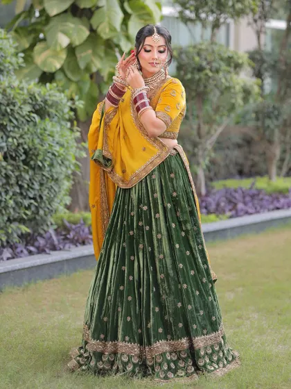 A candid moment of bridal beauty. The soft glam makeup with a pop of red on the rose in her hair adds a touch of romance to this traditional look.