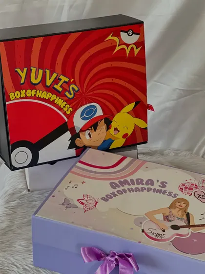 Two different themes for two different personalities. On the left, a popstar-themed 'Box of Happiness' for Amira, and on the right, the Pokémon-themed box for Yuvi.