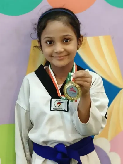 Zainab proudly showing off her gold medal. She is a shining example of what dedication to Poomsae can achieve.