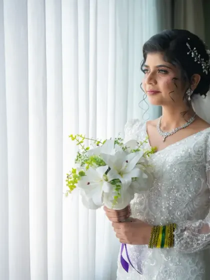 A lovely, natural-looking bridal portrait. The bride looks serene and beautiful as she gazes out the window on her wedding day.