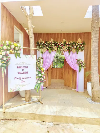 A welcome sign and floral entrance decor for a wedding.