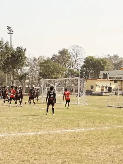 A view of our team organizing for a set-piece situation near the opponent's goal during a Super League fixture.