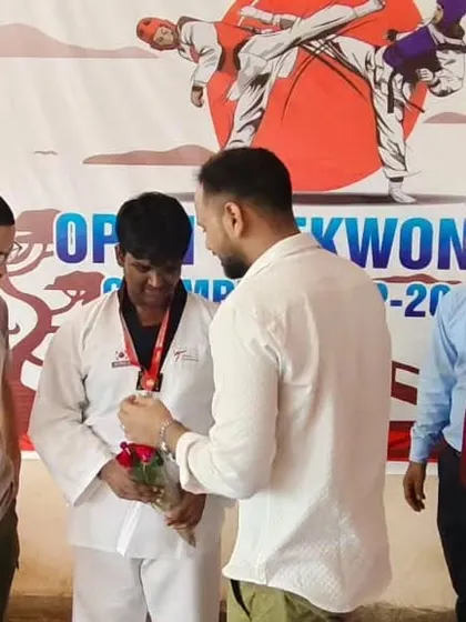 A moment of celebration with one of my students after his win at an open taekwondo championship.
