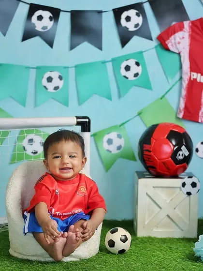 A happy little football fan celebrating his half-birthday. Themed shoots like this are a great way to incorporate your family's passions into your child's photos.