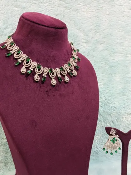This simple AD choker and earring set with emerald stones is a steal. It's perfect for guests or for a low-key pre-wedding event.