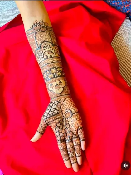 A single-hand design showing a mix of traditional motifs like elephants and lotuses, extending just past the wrist.