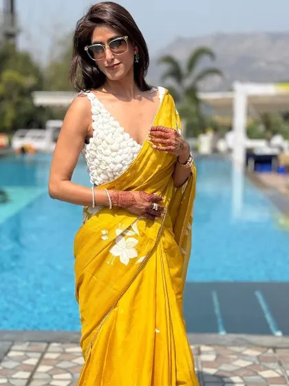 The right accessories complete any look. Here, the focus is on the textured blouse and how it contrasts with the soft organza saree. My simple white bangle and statement ring add just enough detail without overpowering the outfit.