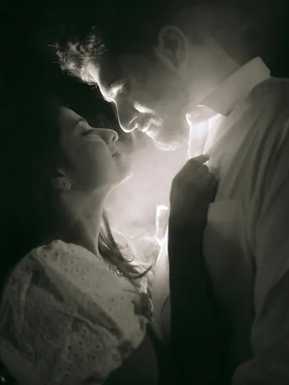 An intensely romantic and artistic close-up, using smoke and light to create a moody, cinematic portrait.